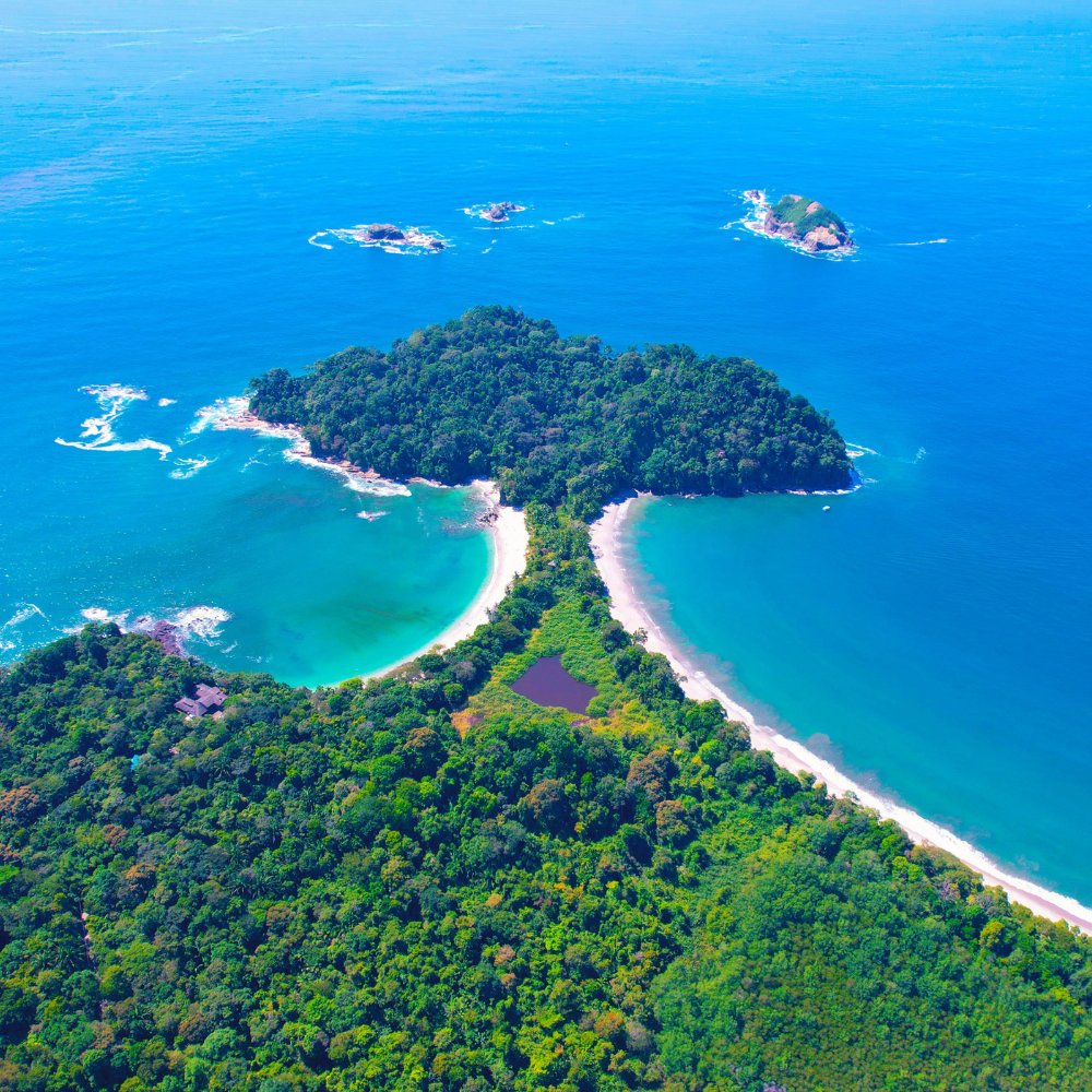 Aerial view of the forested coastline and turquoise bays of Manuel Antonio, Costa Rica