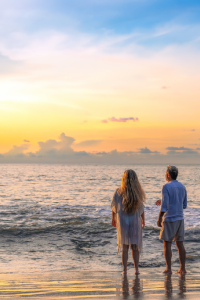 Couple watching the sunset on a Costa Rica beach, reflecting the lifestyle priorities of luxury homebuyers